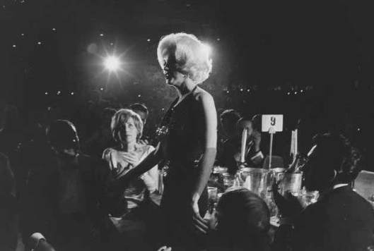 Pat looks on as Marilyn receives a Golden Globe as 'World Film Favourite', 1962.